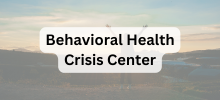 Scenic landscape with rolling hills and open sky, with the text "Behavioral Health Crisis Center" displayed. 