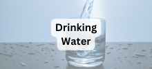 Water being poured into a clear glass on a surface, with the text "Drinking Water" displayed.