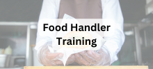 Food service worker wearing gloves and an apron preparing food in a kitchen, with the text "Food Handler Training" displayed.
