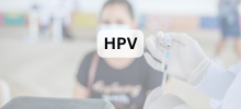 Healthcare worker holding a vial and syringe while preparing a vaccine, with the text "HPV" displayed.