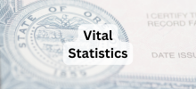 Close-up of an official certificate with a state seal, with the text "Vital Statistics" displayed.