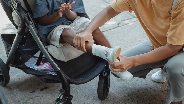 child in stroller with parent
