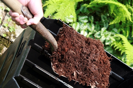 shovel of compost from bin