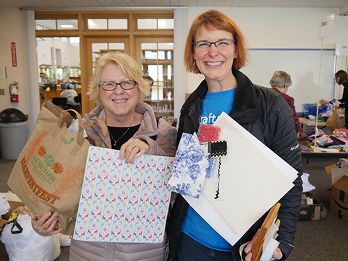 Two women posing with their swap finds