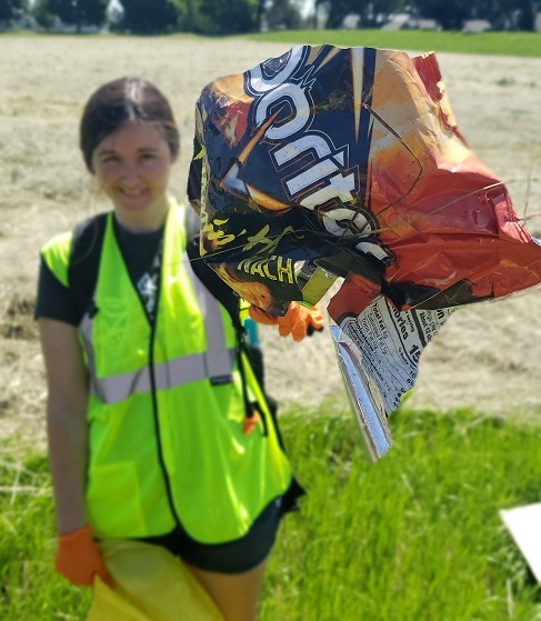 woman picking up trash