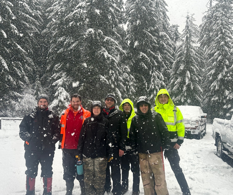 a group photo of search and rescue volunteers in the snow