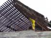 alternative programs staff teach safety while working to bring down an old barn to recycle wood.