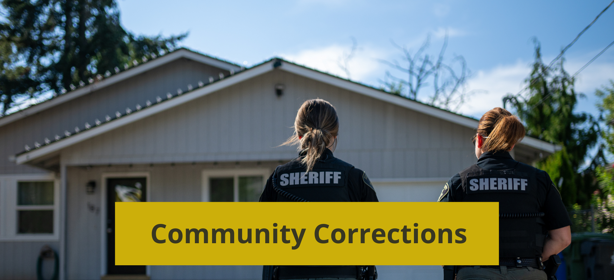 two community corrections females walking towards a house