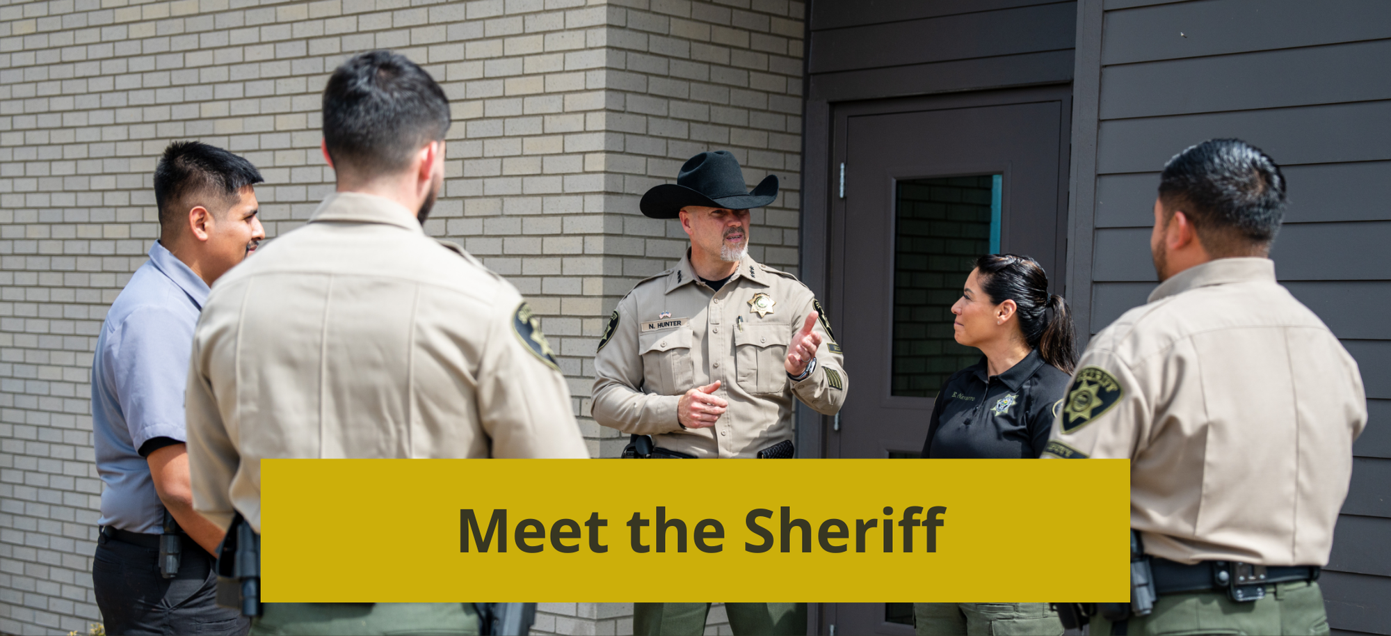 Sheriff Nick Hunter talking with a group of deputies from the Sheriff's Office